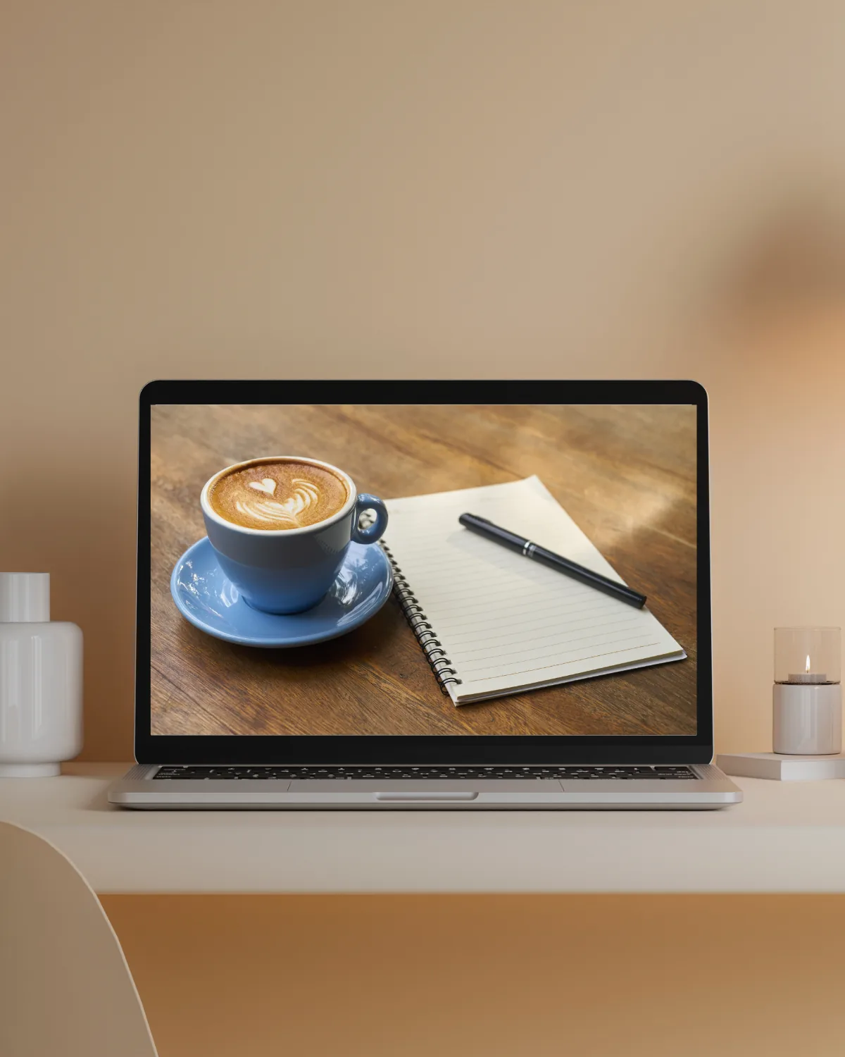 Laptop and coffee on a desk for Claudia’s biopharma insights newsletter